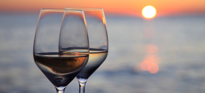 glasses wine against sunset